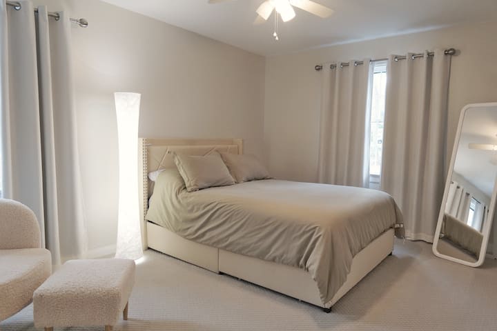 Dormitorio de invitados con una cama tamaño queen y un colchón mediano.