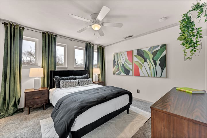 Cozy up in this bedroom with a queen bed and a shared attached bathroom. 