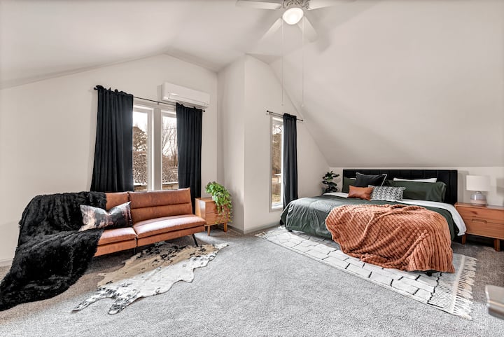 Our upstairs en suite - or second primary suite - has a king bed, sleeper sofa with bedding and attached full bathroom with shower.