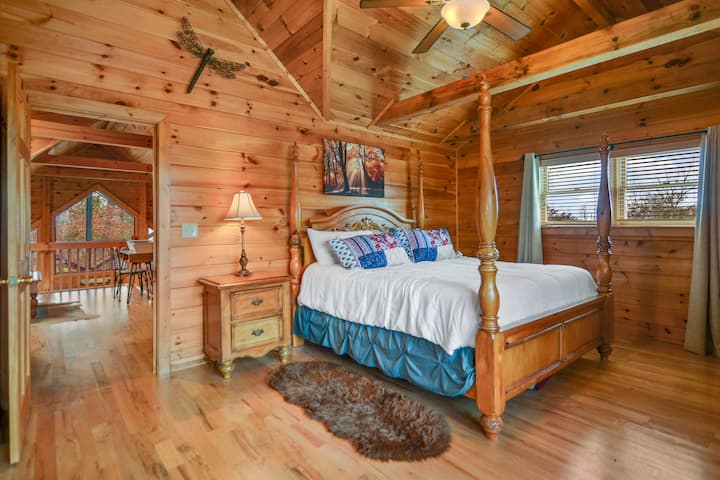 Upstairs master bedroom with King size bed, ceiling fan, and attached full bathroom 