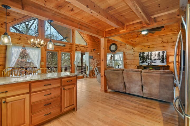 Open Concept Living space with large windows overlooking deck space. Electric Fireplace and large flat screen TV 