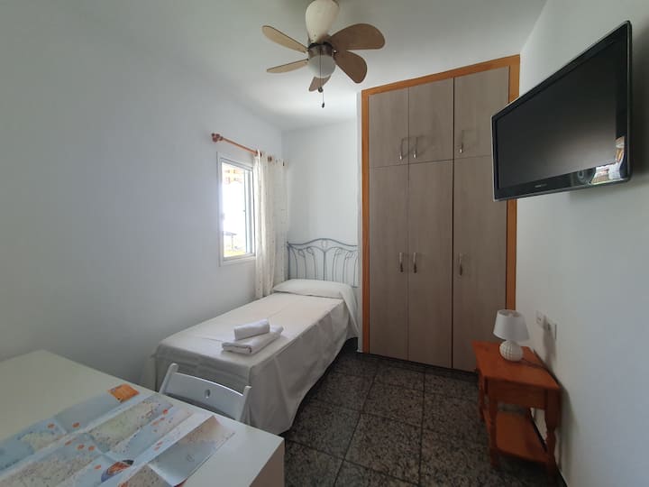 Მესამე ოთახი 90 × 200 საწოლით, ტელევიზორითა და დიდი სამუშაო მაგიდით.