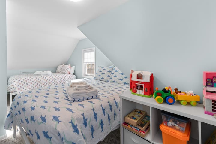 Second floor bedroom with toys and two full beds