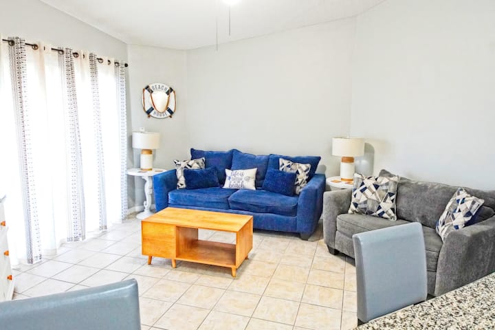 Spacious living room with high ceiling and ceiling fan