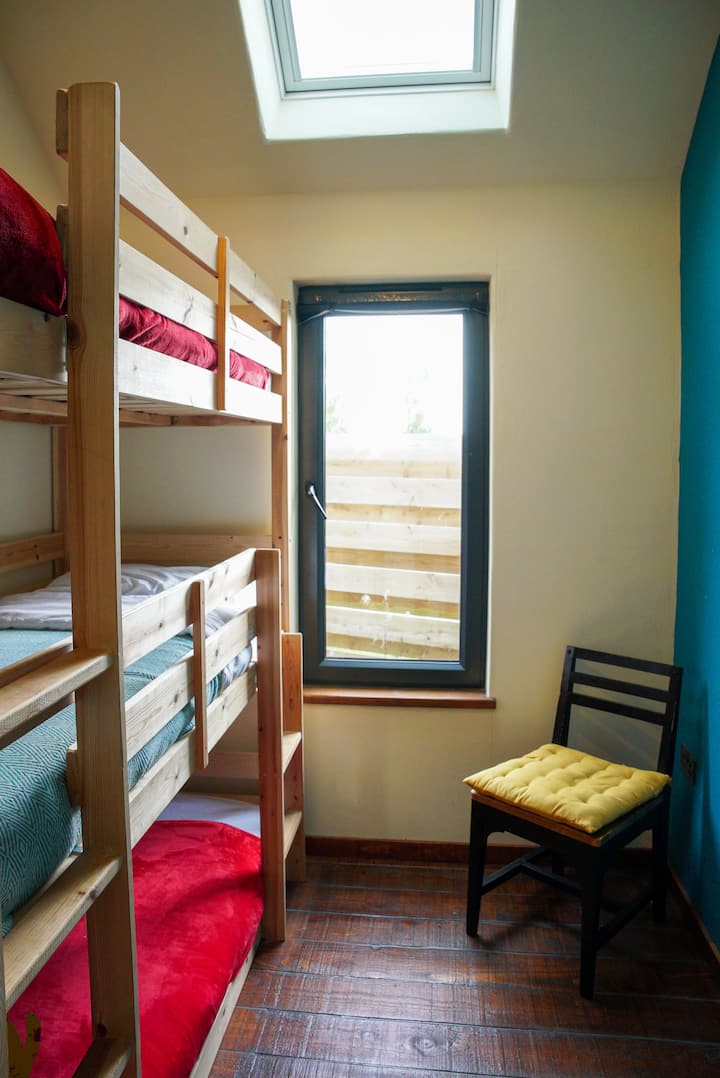 Be snug as a bug in a rug in this solid wood triple bunk bed. Note the size is small single - 190cm x 75cm. With pitched roof, large windows, skylight & art, the second bedroom has a lovely sense of space. The bedroom comes with a wardrobe.