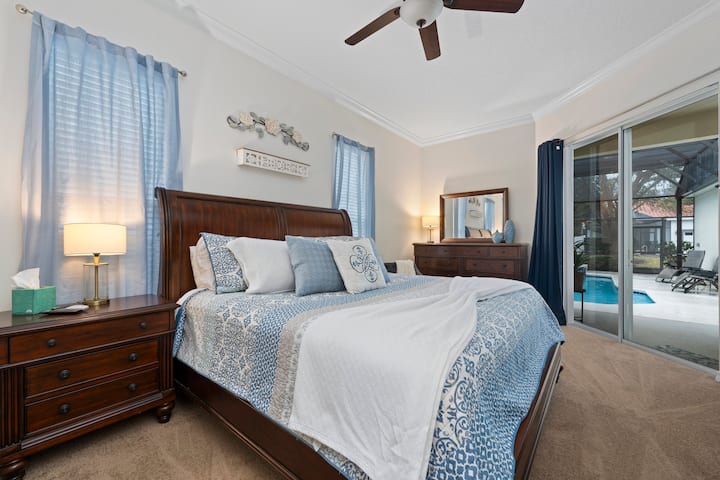 Elegant retreat with pool views, plush bedding, and beach-inspired decor!