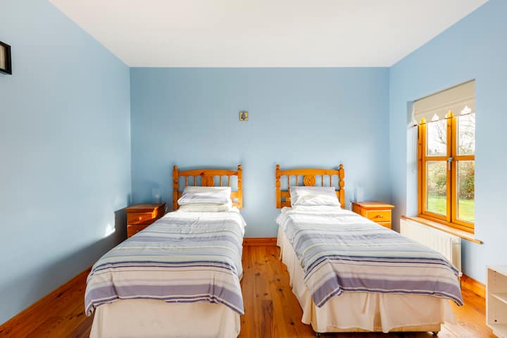 Bedroom 2,  back downstairs bedroom with 2 single beds, lit up by morning sunshine