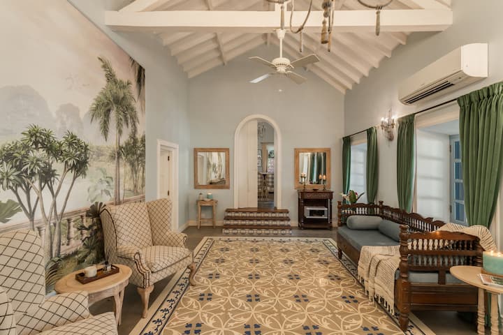 ✨This elegant sitting room blends tropical charm with vintage flair-perfect for quiet conversations or an afternoon read✨