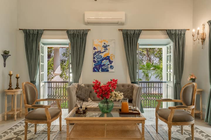 ✨A bright, elegant sitting room with a tufted sofa, classic armchairs, and a cane-glass coffee table-perfect for relaxed moments✨