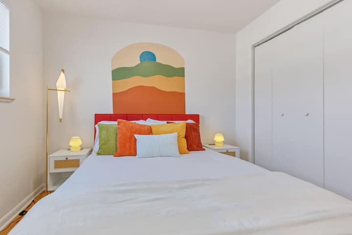 Bedroom featuring a spacious wardrobe for your storage needs and a unique hanging frame that adds a touch of personal style.