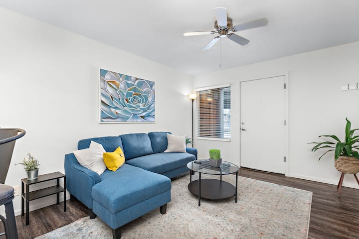 Დაისვენეთ ამ თანამედროვე მისაღებ ოთახში, რომელშიც არის კომფორტული ლურჯი სექციური დივანი, თანამედროვე ხელოვნების ნიმუშები და ჭერის ვენტილატორი. Საცხოვრებელი ნათელი და მიმზიდველია, იდეალურია განტვირთვისთვის ფილმების დათვალიერების ან ღამის სასიამოვნოდ გატარების შემდეგ.