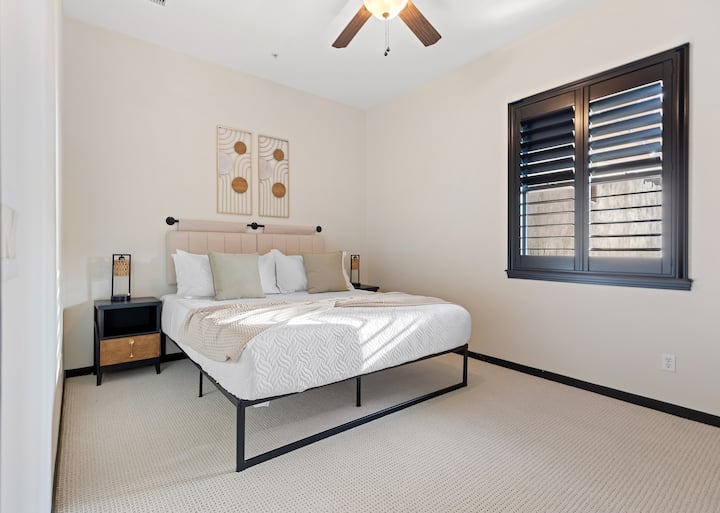 Main level king bedroom with work space and Roku TV