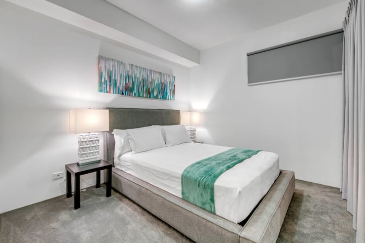 Soft finishes, fresh carpet and a calm queen-bedroom layout give Wild Luxe Beach Front Escape a more settled feel after time in South Bank.