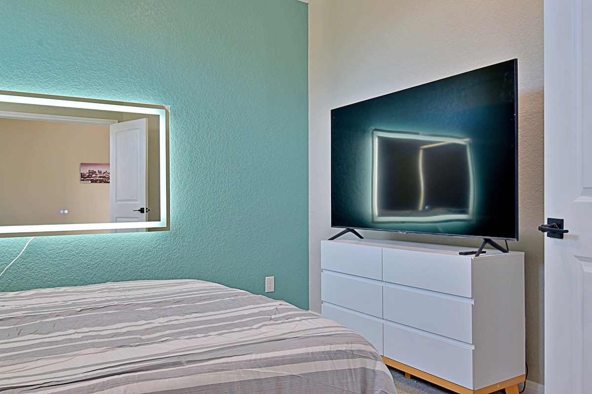Schlafzimmer mit Queensize-Bett und 65-Zoll Samsung 4K-Fernseher
