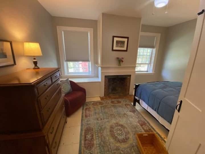 Enter the cozy room with insulated darkening shades. A dresser, reading nook, two end tables and a closet with hangers.