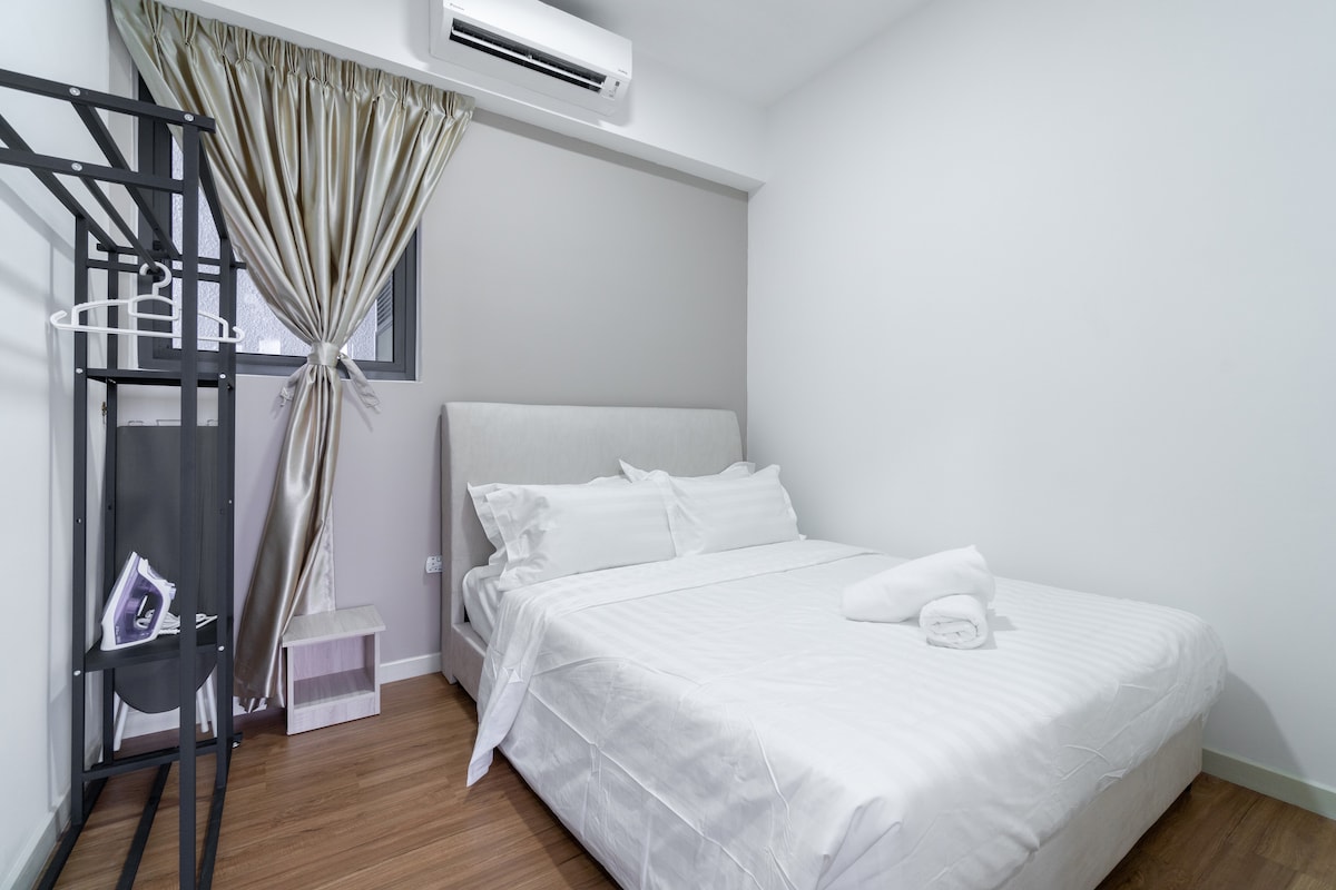 Rest easy in the spacious third bedroom,  furnished with a queen bed, plus iron, board, and hair dryer provided.