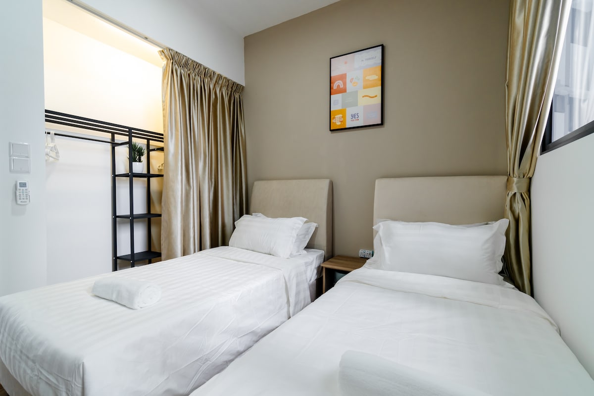 Kick back in the cozy second bedroom, with two single beds and an open wardrobe for your convenience!