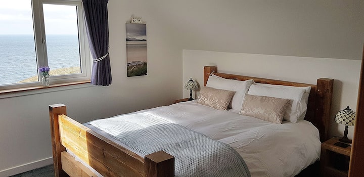 Skye bedroom, with ensuite, king size bed and amazing sea views to the isles