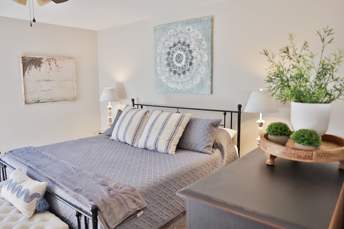 Bedroom 2 with King size bed, end of bed bench and chest of drawers with a Smart Tv