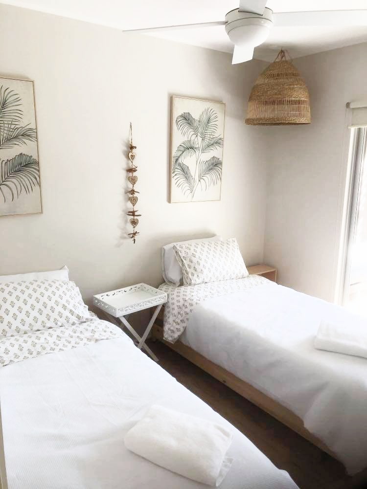 This bedroom has 2 single beds with 2 trundles underneath, perfect for large families. The trundles can be moved to the living area. Remove the side tables to lay out all four beds across the room, creating a fun sleepout style for large groups.  