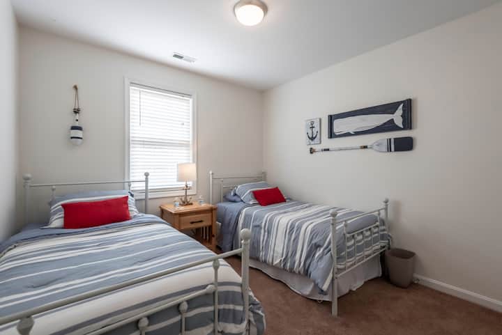 Two twin beds with extra pillows and blankets.