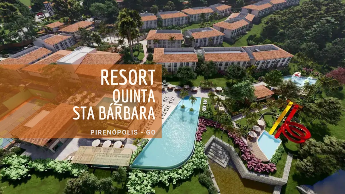 An aerial view of the resort reveals a sprawling layout with multiple buildings surrounded by lush greenery. A large swimming pool is situated at the center, accompanied by lounging areas and water slides, highlighting recreational spaces for guests to enjoy.