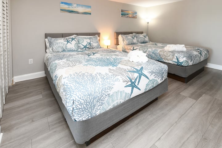 Bedroom features two comfortable queen beds