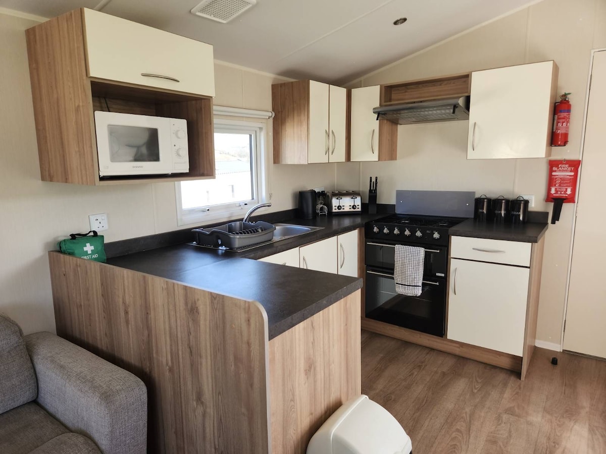 Fully equipped kitchen with a spacious built in fridge/freezer, fire extinguisher/blanket and first Aid kit.
