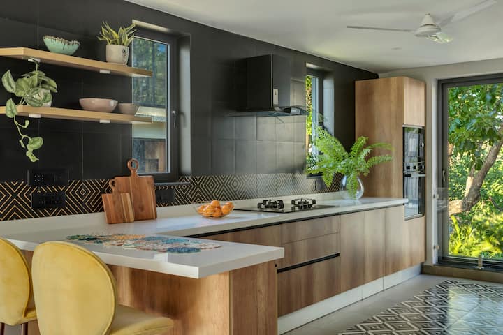 Sleek design meets comfort: A modern kitchen with a touch of homeliness.