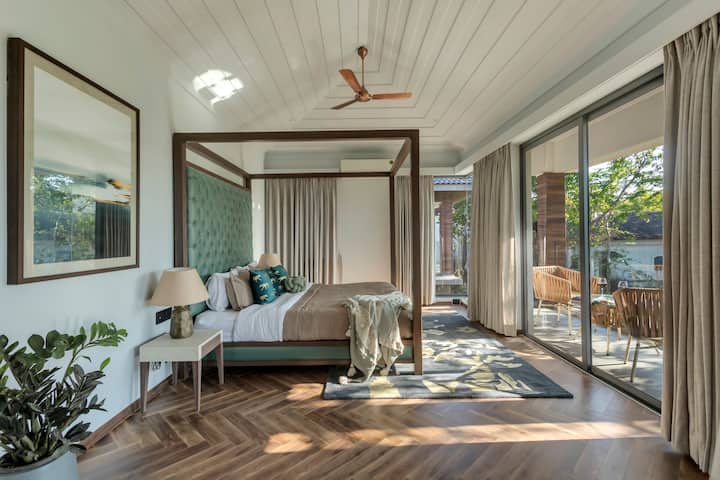A touch of nature inside: Bedroom with a panoramic view and earthy tones.