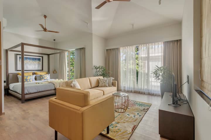 Comfort meets style: A spacious bedroom with a cozy sitting area.