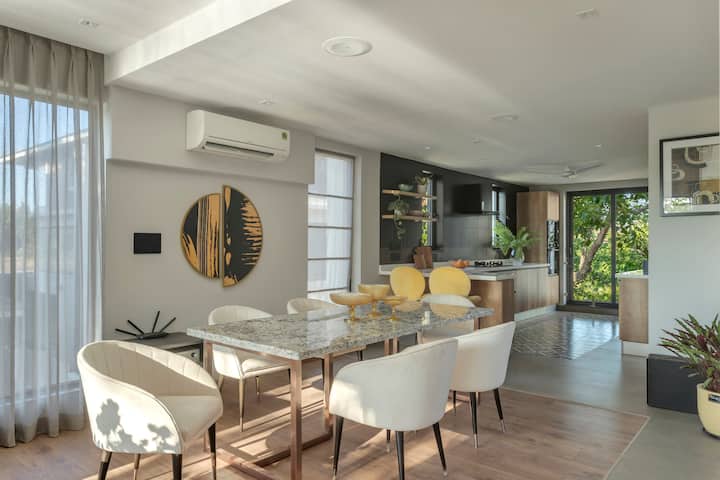 Where elegance meets functionality: A dining area seamlessly connects to a modern kitchen.