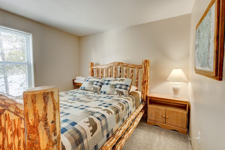 Rest easy in this charming bedroom featuring a handcrafted log bed, cozy bear-themed bedding, and soft natural light. A peaceful retreat after a day of exploring, perfect for unwinding in true cabin comfort.