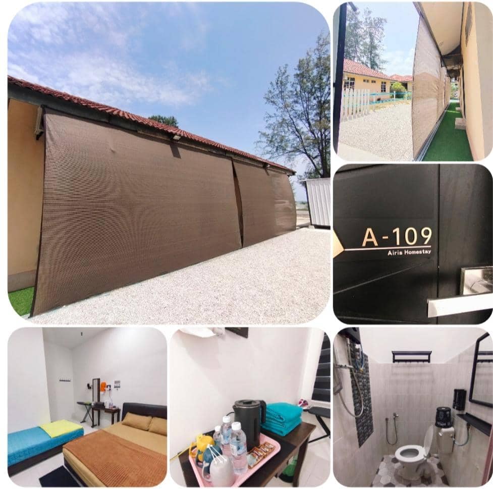The image presents a collage featuring the exterior of Airis Homestay, an entry door marked 'A-109,' a cozy sleeping area with a blue and yellow bed, a small table, and a set of amenities, including bottled water and a kettle. The attached bathroom is visible, showcasing essential fixtures.