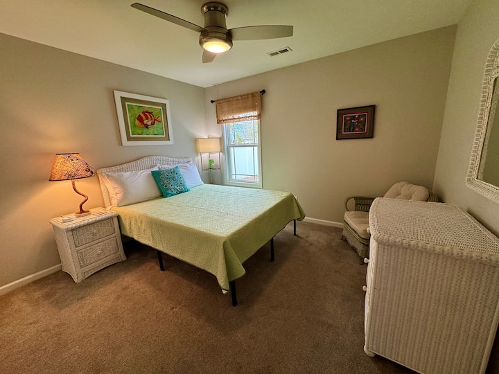Bedroom 2 boasts a queen bed, dresser, and nightstand. 