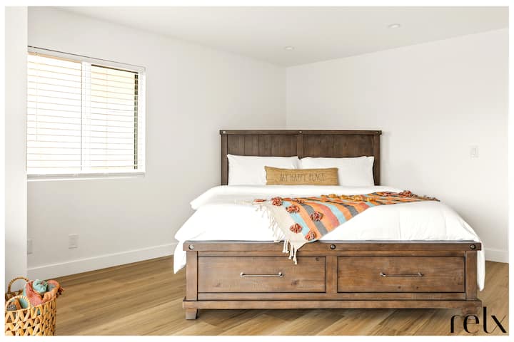 Primary / second level bedroom with King bed,  en suite bathroom and direct access to a private balcony through private sliding glass doors.  