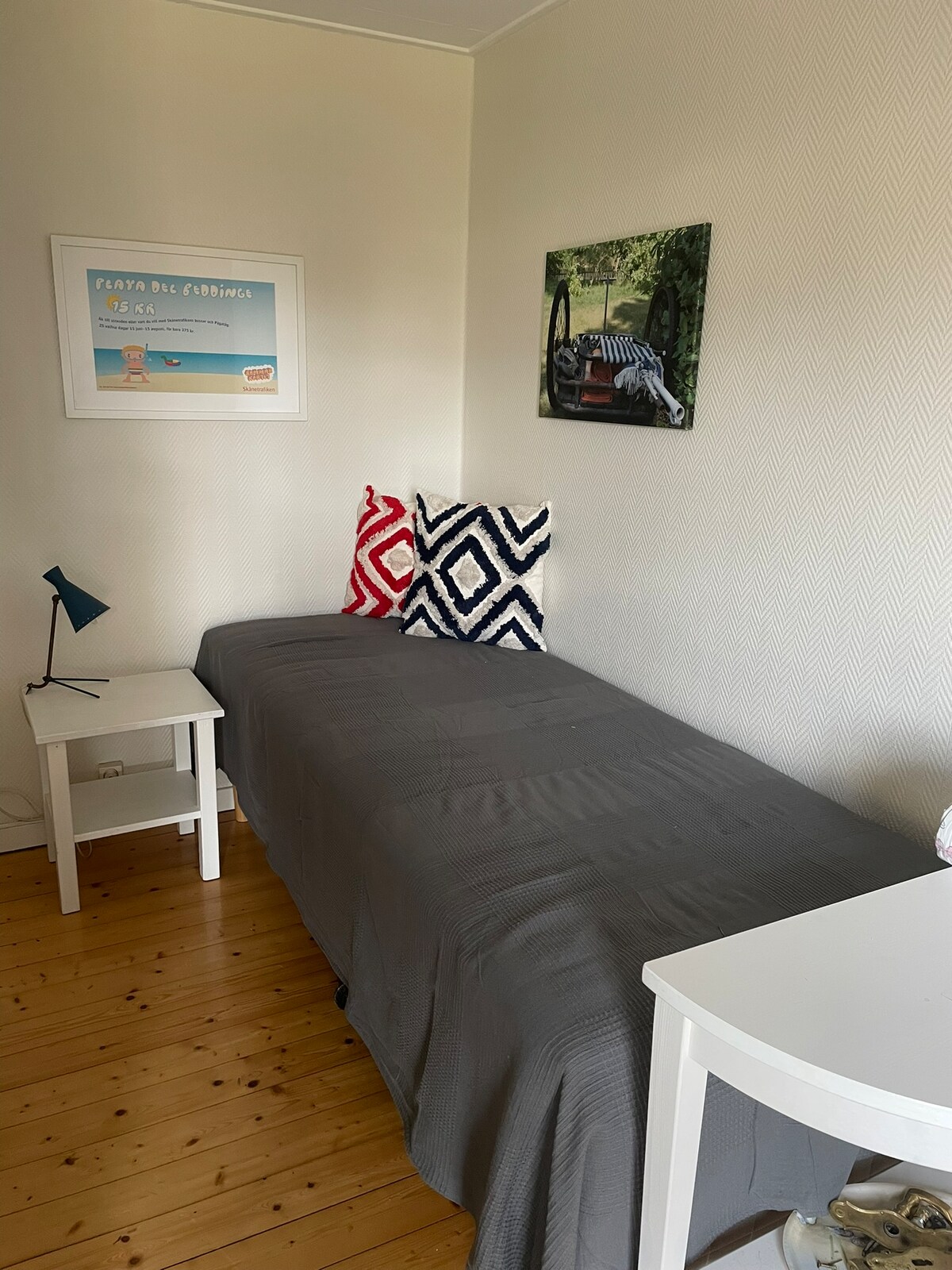 Single bed in sleeping alcove.