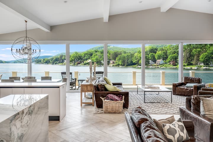 Impeccably adorned with tasteful decor, this expansive open concept boasts panoramic vistas of the glistening lake, inviting you to unwind and bask in its natural splendor.