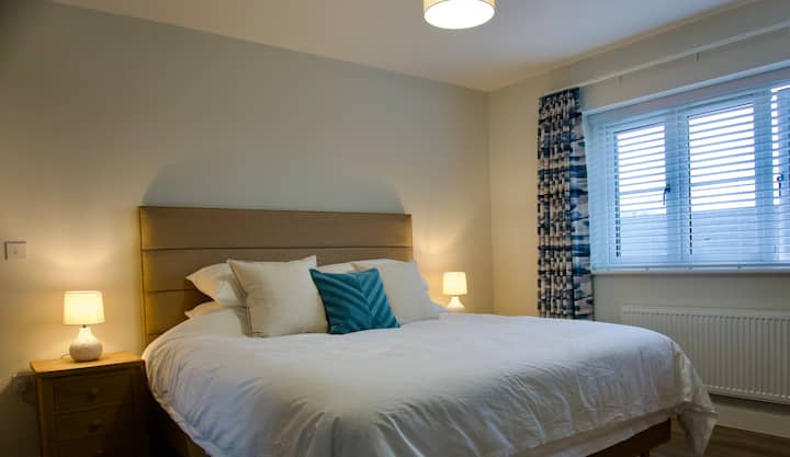 Bedroom 1.  Super King 6ft double bed with top quality 'Sussex' pocket sprung mattress.  John Lewis 400 thread count cotton linen, anti-allergy duvets and pillows.  Handmade inter-lined blackout curtains.