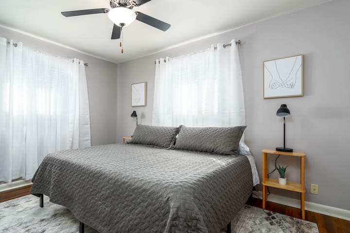 Bedroom 1: Master suite with a king size bed and a night stand.