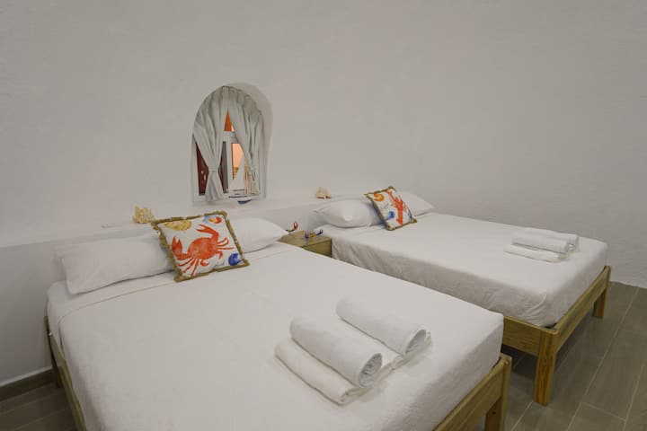 Room with two queen size beds, 42" TV, and air conditioning