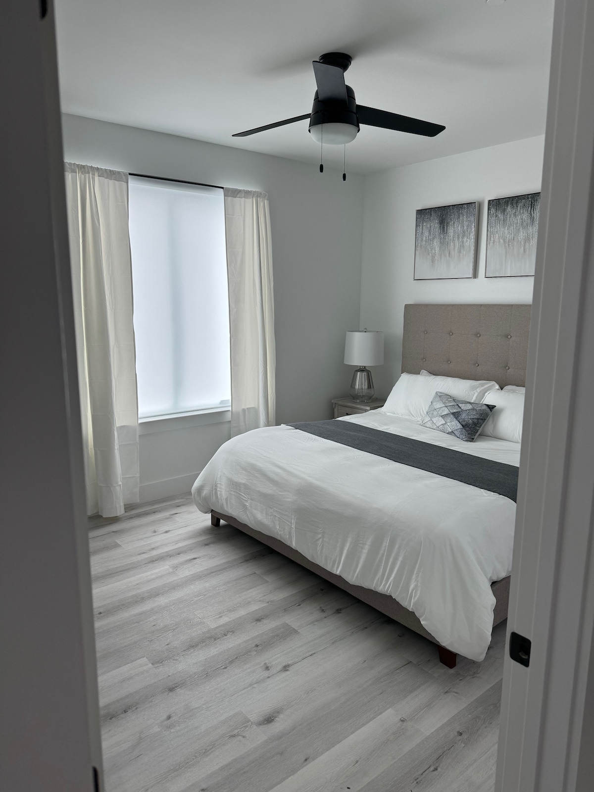 King Sized Bed! Note: bedding maybe differ as comforters are switched out for cleaning.