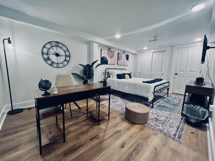 In the bedroom are a smart TV, side lights with plugs and USB charger ports, hangers, laundry hampers, extra linens/pillows, a safe, a closet with cleaning supplies, an outdoor table/chair set, a sound machine, and more. 