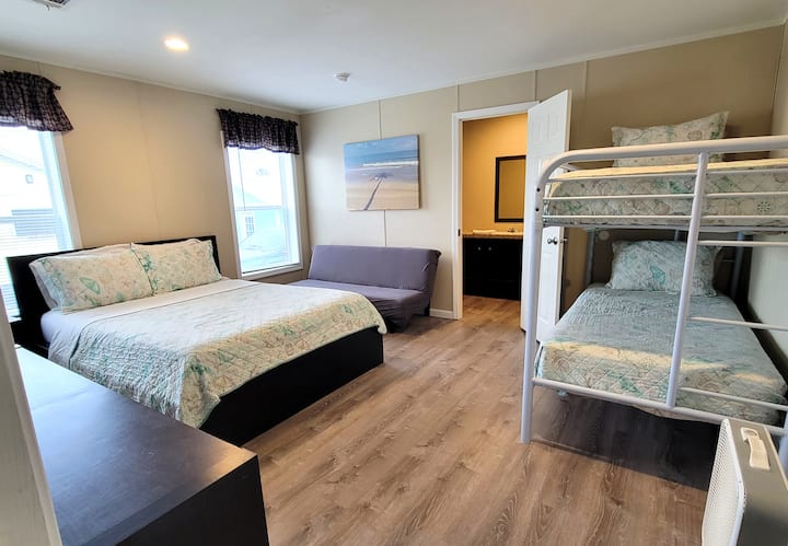 The main bedroom has an attached bath along with a queen bed and a set of bunks.