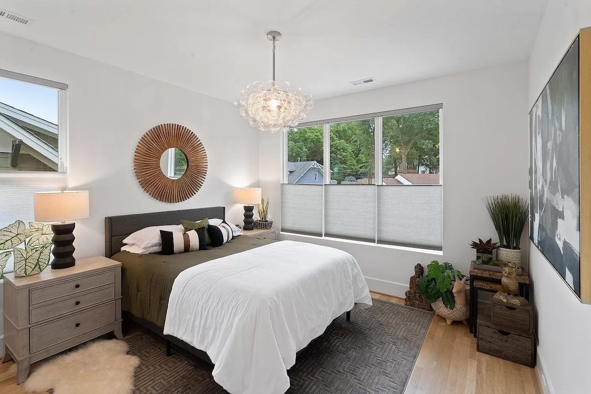 Alójate en el ecléctico dormitorio de invitados del piso superior con una cama tamaño queen, TV y vestidor. Esta habitación de diseño único ofrece comodidad y estilo, perfecta para relajarse después de explorar Charlotte.