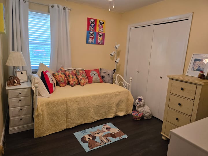 La habitación con temática de perros del festival cuenta con un sofá cama y un montón de espacio para guardar la cómoda.  