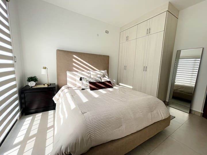 Მთავარი საძინებელი დიდი საწოლით, ტელევიზორითა და საკუთარი სააბაზანოთი.