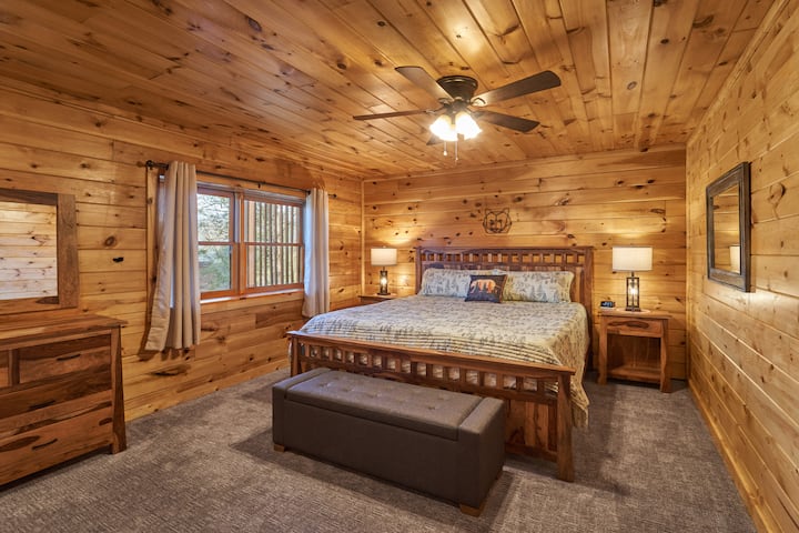 The large lower level bedroom is carpeted for warmth and is furnished with a king bed and quality solid wood furniture. The door out to the lower deck and hot tub is out of frame to the left.   