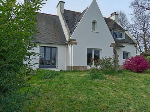 House between forest and a river