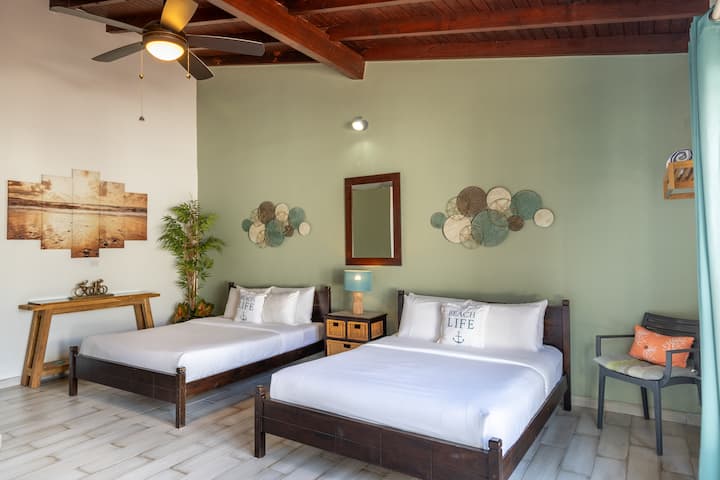Bedroom 5 | Rest peacefully on two queen-size beds and indulge in the added amenities of an ensuite bathroom, sink, and mini-fridge. Experience the perfect blend of relaxation and functionality in this inviting space